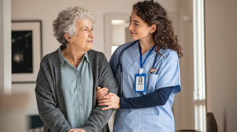 Pflegekraft unterstützt ältere Frau zu Hause